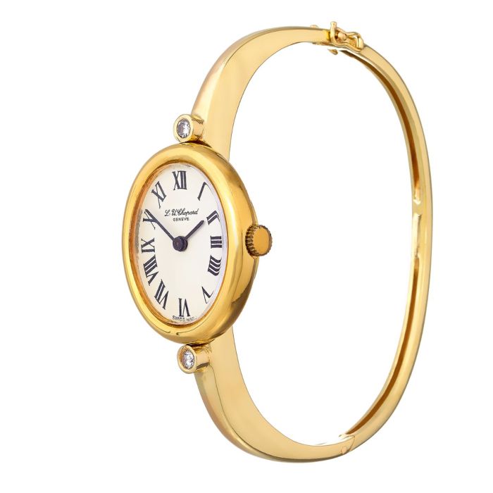 Vintage Luxus-Damenuhr aus dem Hause Chopard in massiver 18-karätiger Gelbgold-Ausführung. Die Armspange ist aus 14-karätigem Gelbgold mit 2 Brillanten ober- und unterhalb des Uhrengehäuses. 