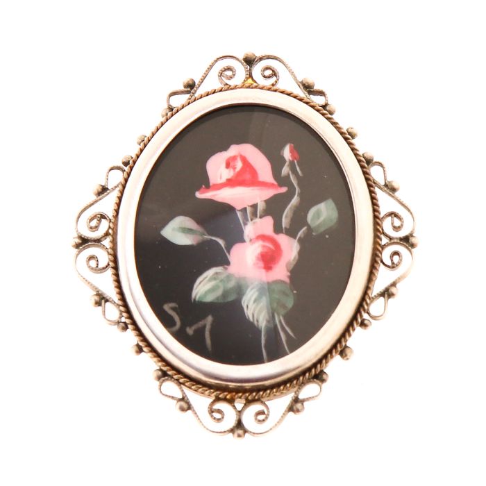 Vintage Anhänger/Brosche aus Silber. Handarbeit. Sie kann auch als Anhänger getragen werden, da eine Öse rückseitig befestigt ist. Ein Blumengemälde - geschützt durch ein Plexiglas - ziert dieses Schmuckstück. Die filigrane Rahmung lockert die schlichte F