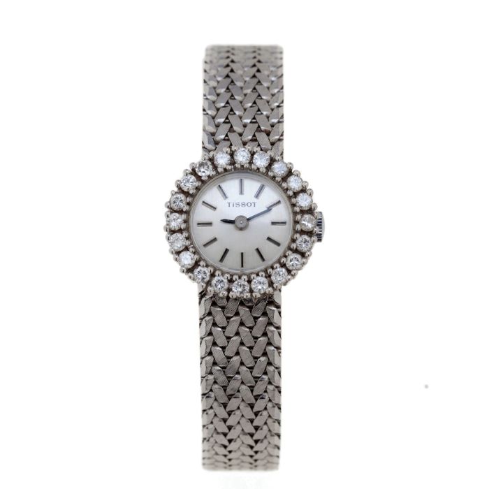 Vintage Damen-Armbanduhr in 585er Weißgold von Tissot / Schweiz um 1960, Lünette besetzt mit 20 Brillanten zus. ca. 0,60 ct. (Weiß, Si2). Zifferblatt mit Strichen als Indizes, massives Schmuckband schauseitig mattiert mit Clipverschluss