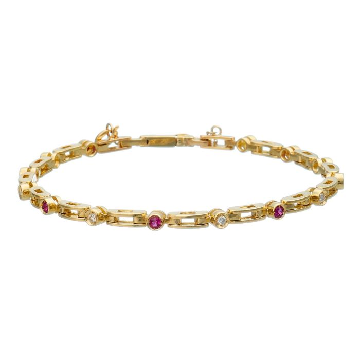 Armband in 14-karätigem Gold. Die stegförmige Gliederform ist mit runden Zwischenelementen, die jeweils abwechselnd einen Rubin und einen Brillant fassen. 
