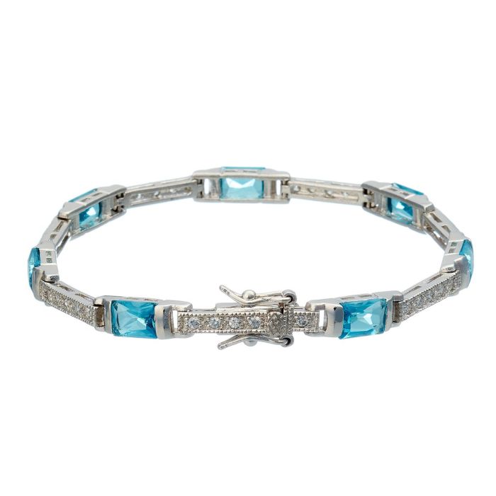 Armband aus 925er Silber. Stabförmige Glieder sind besetzt mit jeweils 5 Zirkonia. Zwischen den Gliedern lockern rechteckige Elemente mit türkisfarbenen Steinen das Schmuckstück auf.