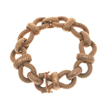 Vintage Armband aus 18-karätigem Gold. Die sehr großen, massiven Glieder ähneln mehreren hintereinander gebundenen groben Knoten.

