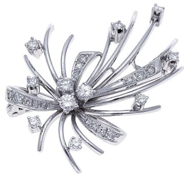 Exclusive, traumhafte Brosche in 14-karätigem Weißgold. Sie wirkt wie eine Schleife mit vielen darangebundenen Bändern. Die 3 großen Brillanten stellen den Knoten der Schleife dar.
